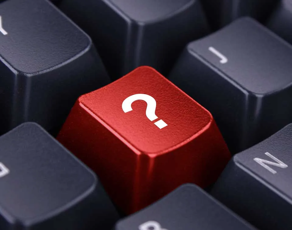 A red question-mark key on a computer keyboard